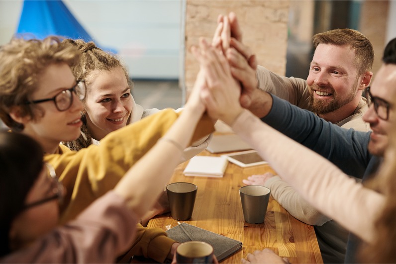 Team high fiving following the success of their B2B inbound marketing Growth Plan